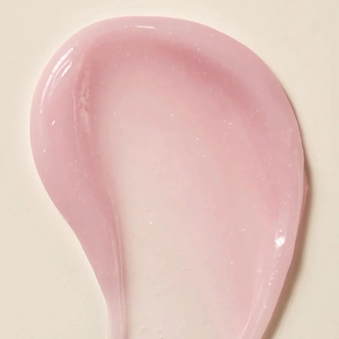 Axis-Y Calamine Pore Control apsule Serum texture reference. The serum is of a light pink gel consistency with tiny capsules in it.